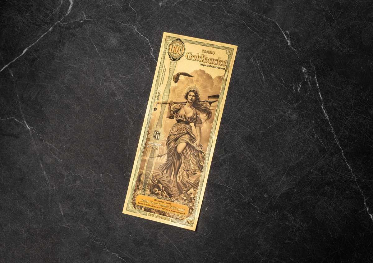 Goldback currency note on a dark surface during the product campaign