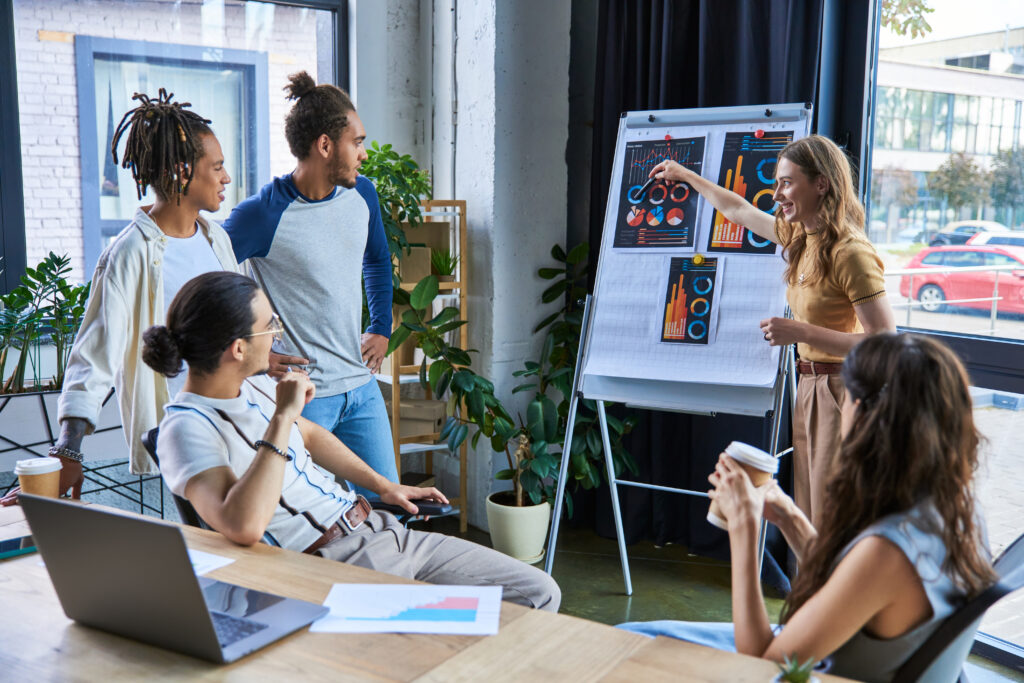 Marketing team discussing data-driven strategies and analyzing campaign performance charts during a team meeting.